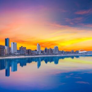 Vibrant Durban beachfront skyline wallpaper mural at sunset with golden hour reflections on the water.